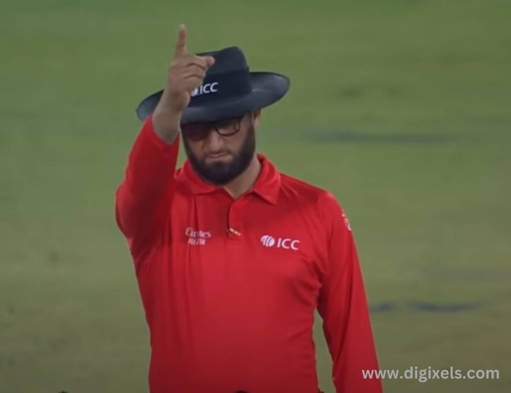 Cricket images of Umpire calling out, lifting finger, red color uniform.