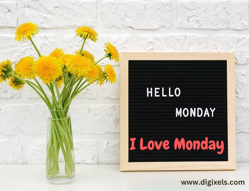 Happy Monday Images with quotes, text written on black board, flowers bundle kept on the glass