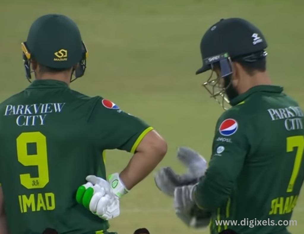 Cricket images of Pakistan two player standing side by side, wearing helmet, uniform, hand gloves