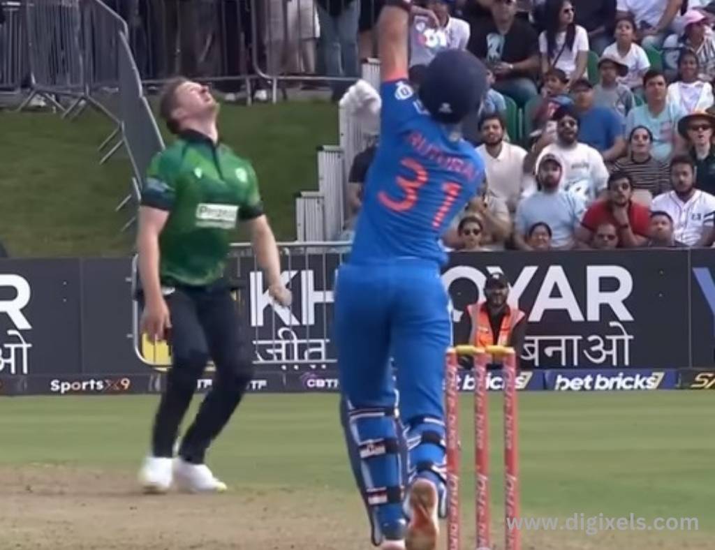 Cricket images of India vs. Ireland, India batsman, hitting ball, Ireland bowler looking up the ball.