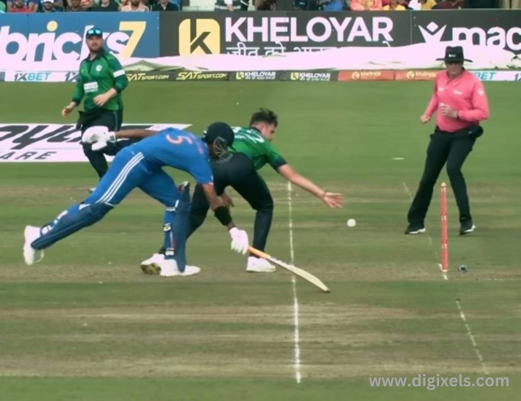 Cricket images of India vs. Ireland T20 Match, India batsman running for a run, got on the line, Ireland keeper trying stamping the ball.