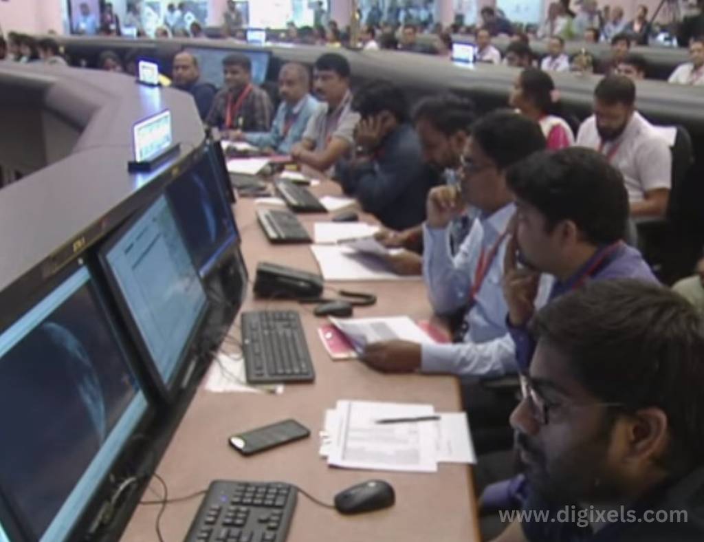 Chandrayaan 3 images, a group of team of chandrayaan 3 mission are sitting in ISRO center, people are checking and viewing chandrayaan 3 landing on Moon.