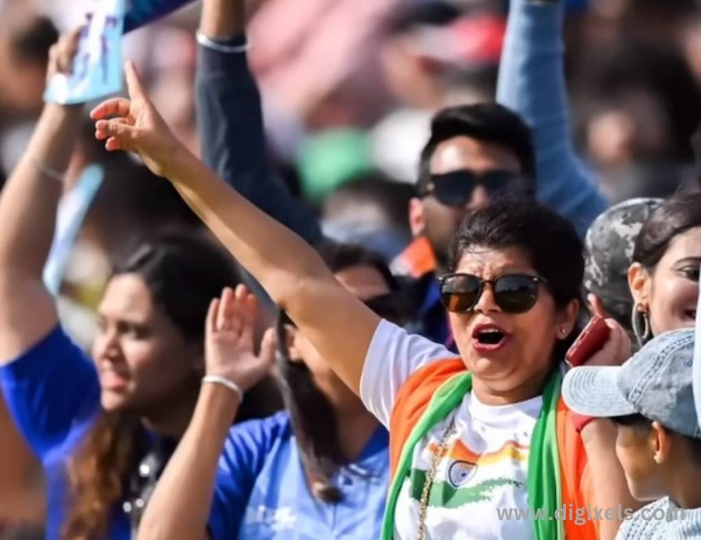 Cricket images of India supporters screaming and enjoying the match , a girl putting on the Tiranga on the shoulder.